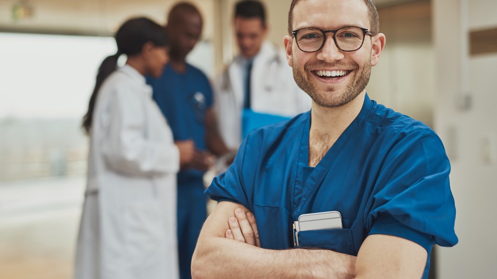 NHS At Work Junior Doctor smiling at camera